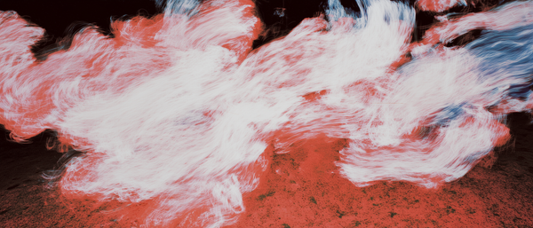 Abstract motion blur of red and white light against a dark background